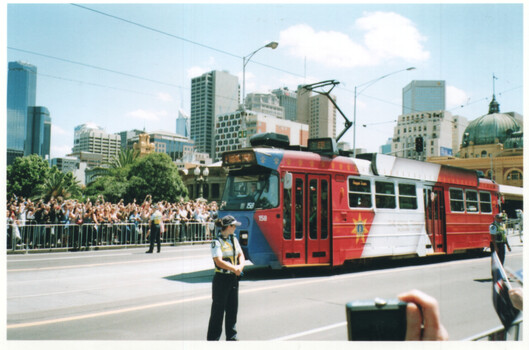 Arms upstretched as the Queen passes by.