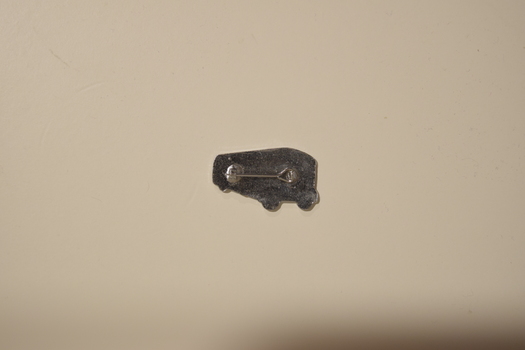 A metal badge in the form of an AEC Regal Mk3 bus.