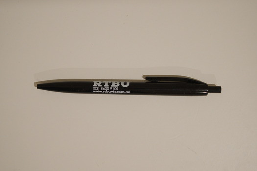 Black retractable pen with white text printed on the side advertising the RTBU.