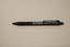 Black retractable pen with white text printed on the side advertising the RTBU.