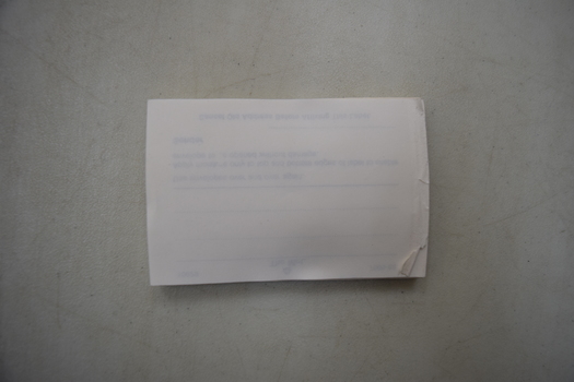 Unprinted side of a stack of envelope labels to seal envelopes.