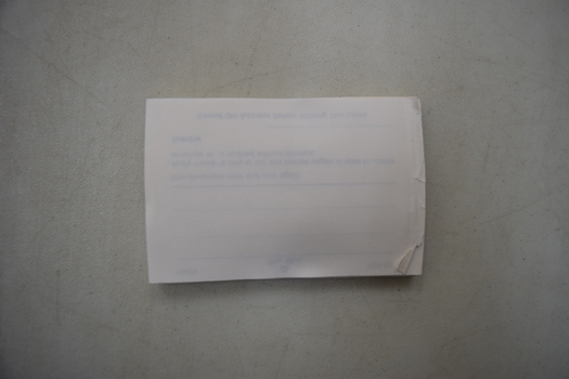 Unprinted side of a stack of envelope labels to seal envelopes.