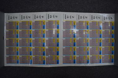 A sheet of laminated paper with multiple copies of PTC scratch tickets printed.