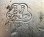 Round tramway ground indicator roadway stud - close up of manufacturer's stamp