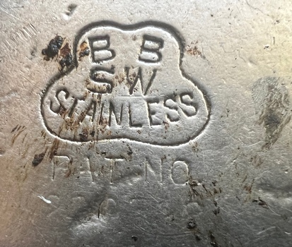 Round tramway ground indicator roadway stud - close up of manufacturer's stamp
