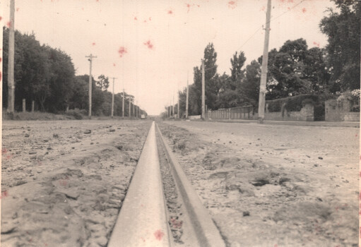 View of tramway track showing the broken condition of the roadway on either side of the rail itself.
