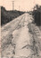 Road surface after removal of the rails showing broken sleepers and very poor rough roadway.