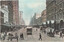 View of Elizabeth Street in Melbourne, Australia, looking north, showing a bustling street scene with horse-drawn carriages, a tram labeled "B. Brunswick 38," pedestrians, and tall Victorian-era buildings lining both sides of the street.