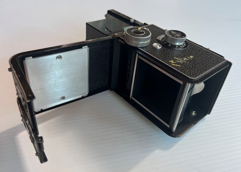 Camera with film compartment opened.
