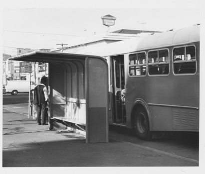 Older style metal modular passenger shelter at bus stop