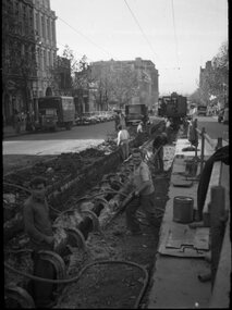 Demolishing cable tram track Bourke St.