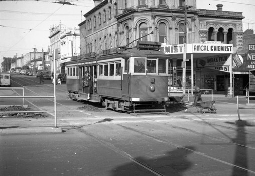 VR tram 32 arriving at St Kilda Station with conductress on step board.