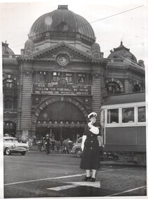 Flinders and Swanston St and policewomen on traffic control duties.