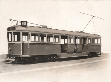 A vintage tram numbered 670 and labeled "CITY" is shown from the side. The tram has multiple windows and doors and is equipped with a trolley pole.