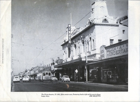 A busy street scene in Footscray, Australia during the 1950s. A tram, identified as X1 466, travels down the street alongside several 1950s model cars. The iconic Fiesta Theatre building dominates the right side of the image, with its distinctive facade and vertical "FIESTA" sign. Adjacent to the theatre, a storefront sign reads "WALTER A. UNDERTAKER 1852". The street is lined with shops, and overhead wires suggest electric transport.