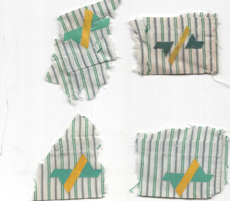 Four ripped fabric scraps with vertical green and gray stripes, each featuring a yellow diagonal stripe overlaid on teal chevron shapes.