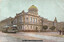 A vintage postcard shows the Law Courts building in Melbourne, Australia, featuring a prominent golden dome. A green tram with "WEST MELBOURNE" written on its side is on the street in front of the imposing classical architecture of the courts. Several figures are visible on the street, along with a horse-drawn carriage.
