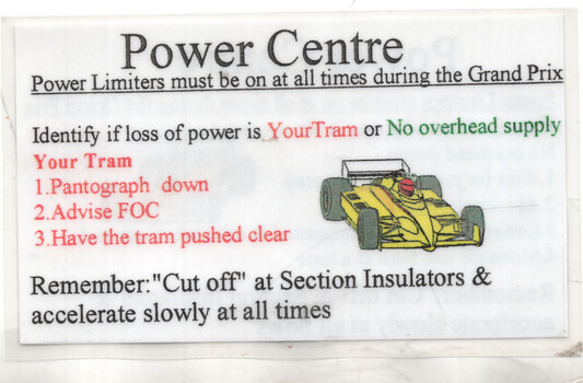 A sign titled "Power Centre" with instructions for a Grand Prix, including a diagram of a yellow race car and bullet points about power loss and safety procedures.
