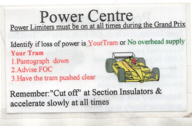 A sign titled "Power Centre" with instructions for a Grand Prix, including a diagram of a yellow race car and bullet points about power loss and safety procedures.