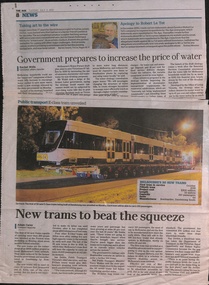Has a photo of the new tram on a truck being delivered at night.