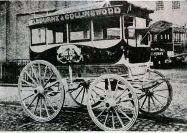 Horse-drawn omnibus labeled "MELBOURNE & COLLINGWOOD" with ornate decoration on its side, parked on a cobbled street.