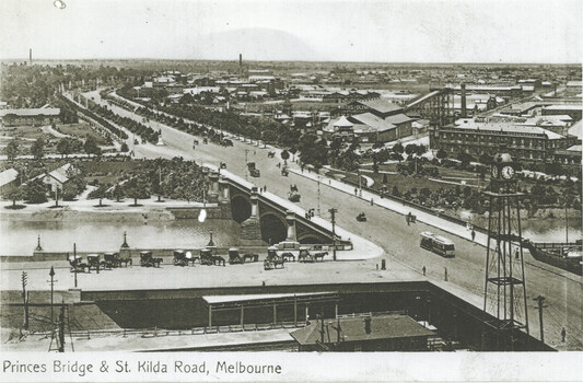 Aerial view of Princes Bridge and St. Kilda Road in Melbourne, showing horse-drawn carriages, early automobiles, and a tram on the road, with a large cityscape.