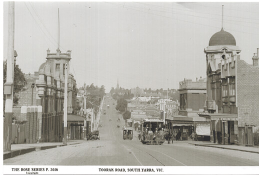 Street scene of Toorak Road in South Yarra, Victoria, showing cable trams on a tree-lined road with Victorian-era buildings.