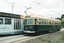 A vintage green and cream tram numbered 53, labeled "SPECIAL" on top, stands on tram tracks beside a modern silver tram with "YARRA TRAMS" branding and a "Bundaberg Ginger Beer" advertisement.