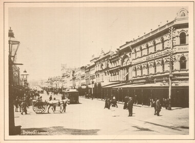 A bustling street scene with horse-drawn carts and early trams, lined with ornate, multi-story Victorian-era buildings, some with signs indicating businesses like "BEATH, SHIRT & CLOTHING CO."