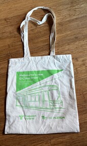 Cream colored linen tote bag with a green graphic of Melbourne's new G Class tram, text reading "Melbourne's new G Class tram" and "Made in Victoria for Victoria". The bag also features logos for Transport Victoria and Alstom.