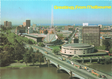 Aerial view of Melbourne cityscape with a prominent spire, a domed building, and a bridge spanning a river, with a line of trams on the bridge and "Greetings From Melbourne" text at the top.
