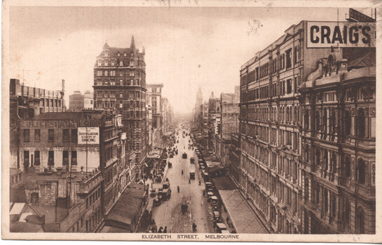Vintage sepia-toned postcard view looking down a bustling street lined with multi-story buildings, featuring cable trams, horse-drawn carriages, early automobiles, and pedestrians, with a sign for "CRAIG'S" prominently displayed on a building facade.