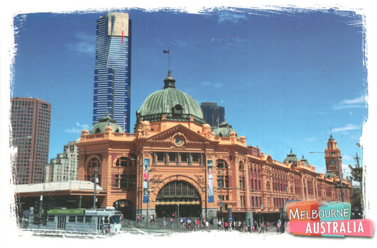A wide shot of the historic Melbourne Flinders St Station in Australia, featuring its iconic dome and ornate orange facade, with a modern skyscraper visible in the background and a tram in the foreground.