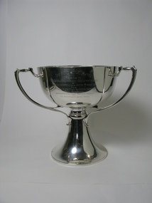 A silver trophy with two visible angular handles.