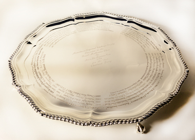 A 14-sided silver tray with wavy edges given a floral appearance.