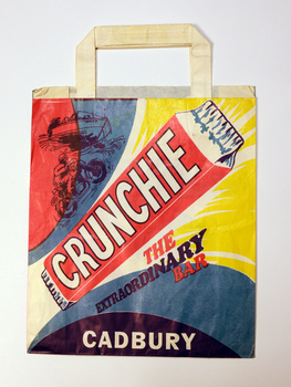 A showbag, showing an illustration of a Crunchie bar with a motorbike, boat, and swirling colours.