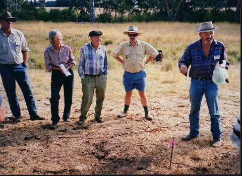 Colour photograph depicting four people listening to presenter Camille Veselsky. 