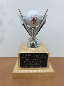 Commemorative Golf Ball: New clubhouse opening 1998. Golf ball on silver coloured mount and timber base.