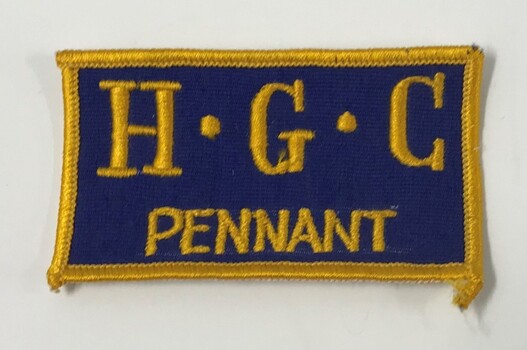 Blue fabric patch embroidered with yellow letters used by Heidelberg Golf Club Pennant teams