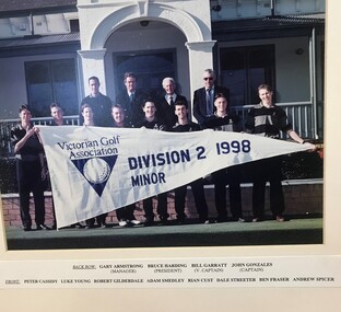 Team photograph of group of golfers holding pennant
