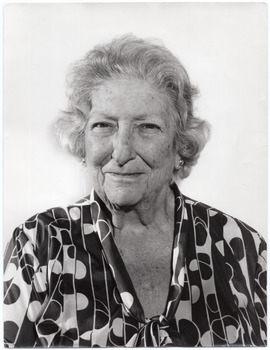 B&W portrait of a woman wearing a dress in a bold geometric-patterned fabric.