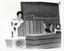 B&W photo of a woman standing at a podium built into a large wooden desk. Three people are seated behind the desk. On a small table, beside the podium, is a large slide projector.