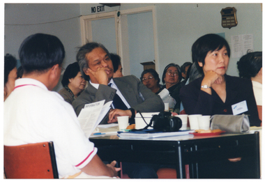 COL close up photo of seminar participants seated at a tables.
