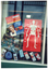 COL photo of three large posters and several information brochures adorning a shop window.