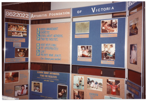 COL photo of a large freestanding four-panel display board. Across the top of the two centre panels is the text "ARTHRITIS FOUNDATION OF VICTORIA", with the phone number "8622022" across the top of each side panel. Using the words 'Self Help' as an acronym, one centre panel contains the following text: S STRESS MANAGEMENT. E EXERCISE. L LEARN ABOUT ARTHRITIS. F FIND THE FACILITIES. H HEAT HELPS PAIN. E EAT APPROPRIATELY. L LIVE! P PROTECT YOUR JOINTS. This is followed by some text in italics, "Can change your outlook". Other panels contain information and photos pertaining to diet and nutrition, exercise, pain management, and other topics.