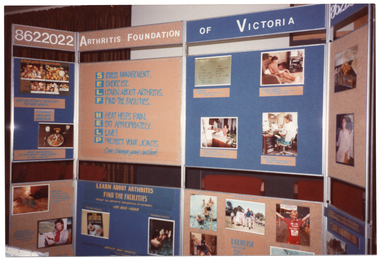 COL photo of a large freestanding four-panel display board. Across the top of the two centre panels is the text "ARTHRITIS FOUNDATION OF VICTORIA", with the phone number "8622022" across the top of each side panel. Using the words 'Self Help' as an acronym, one centre panel contains the following text: S STRESS MANAGEMENT. E EXERCISE. L LEARN ABOUT ARTHRITIS. F FIND THE FACILITIES. H HEAT HELPS PAIN. E EAT APPROPRIATELY. L LIVE! P PROTECT YOUR JOINTS. This is followed by some text in italics, "Can change your outlook". Other panels contain information and photos pertaining to diet and nutrition, exercise, pain management, and other topics.
