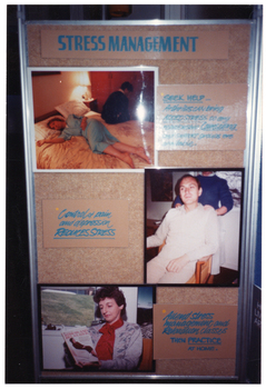 COL photo of a large freestanding display board. Under the heading "STRESS MANAGEMENT" are three photos, each with some accompanying text. The first photo depicts a woman lying on her side in bed, while a man sits on the edge of the other side of the bed. They have their backs to one another. The accompanying text is, "SEEK HELP... Arthritis can bring ADDED STRESS to any relationship. Counselling and support groups are available." The second photo depicts a man sitting in a chair, with a woman behind him massaging his shoulders. The accompanying text is, "Control of pain and depression REDUCES STRESS". The third photo depicts a woman sitting in a chair by a window. She is reading a book titled, "Stress and Relaxation". The accompanying text is, "Attend Stress management and Relaxation classes THEN PRACTICE AT HOME."