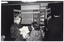 B&W photo of four people standing in front of a multipanel display board. Displayed across the top of the centre board is the text, "ARTHRITIS FOUNDATION OF VICTORIA", with the phone number "8622022" across the top of the two side panels.