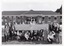 B&W photo of a group of people gathered around a large sign, which is situated in the front yard of a brick building. The text on the sign is: "ARTHRITIS FOUNDATION OF VICTORIA INC EST 1968 THE PERCY BAXTER ARTHRITIS CENTRE". Above the text is a logo.