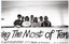 B&W photo of a small group of women standing behind a barrier on a viewing platform or balcony. On the barricade, there is a large banner (partially obscured) with the text, "Making The Most of Tenhis" and "... ARTHRITIS FOUNDATION of VICTORIA" (partially obscured).